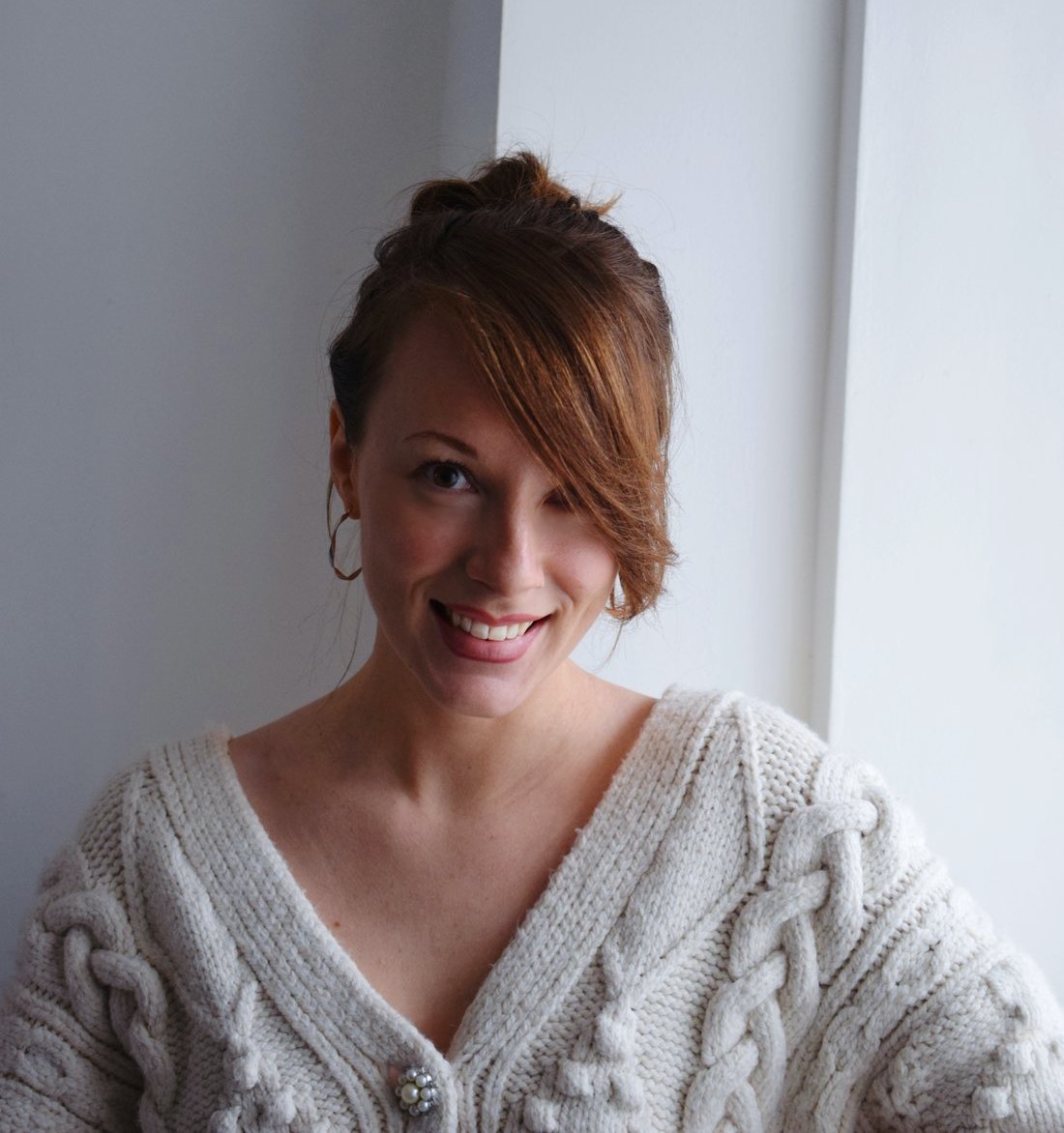 Jessica Duffin in a cream cardigan, smiling